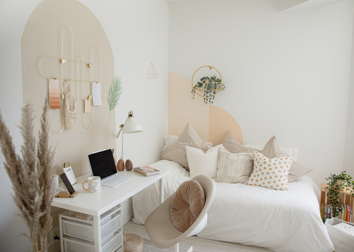 Neatly arranged bedroom with a desk, bed, and decorative elements.